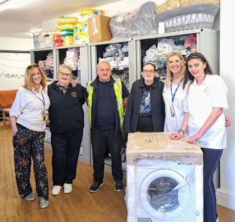 BREE Construction team with Baby Kind volunteers and a donated washing machine