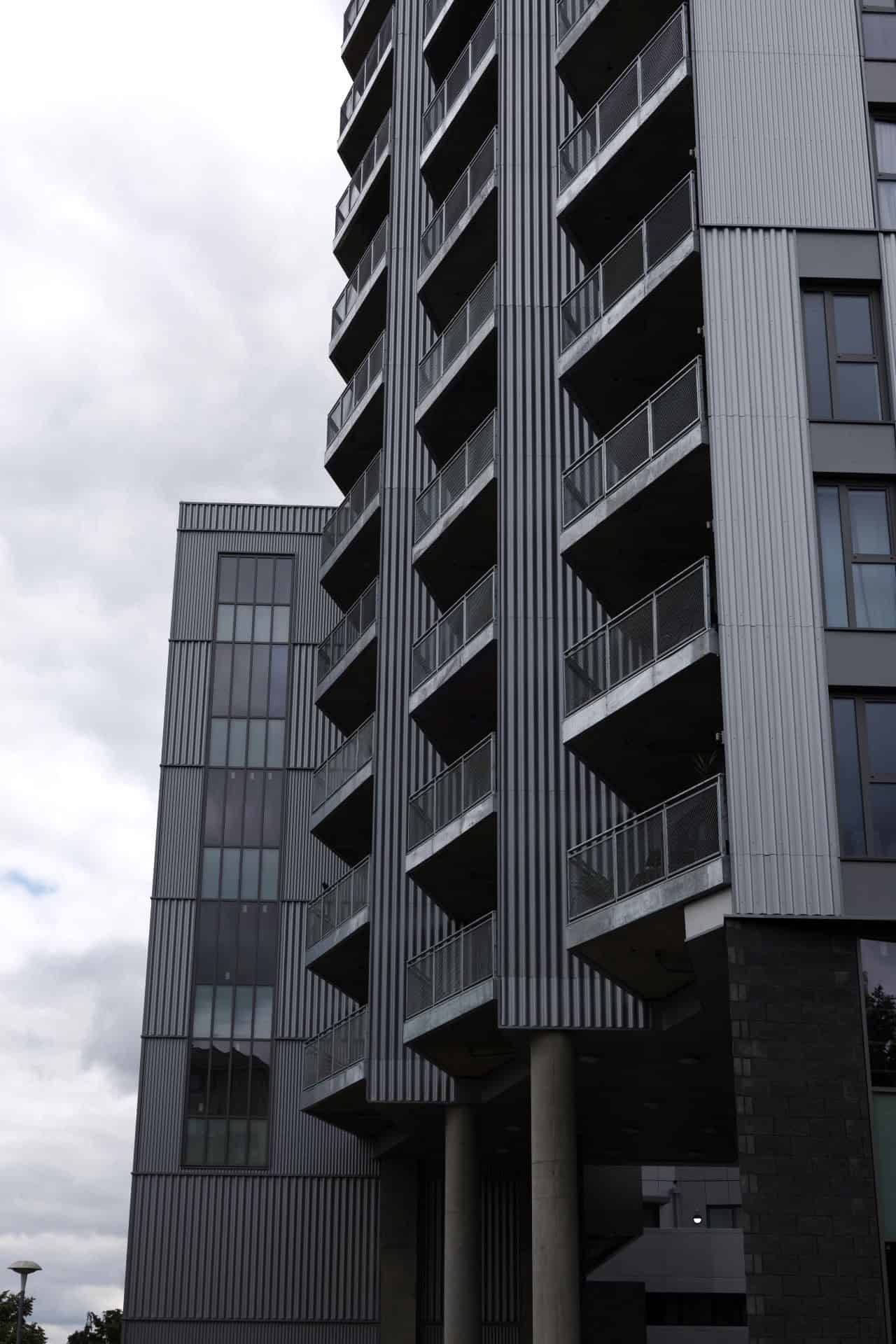 Burnt Oak Broadway, Barnet: close-up of the corrugated cladding and cantilevered balcony rhythm on the tower facade