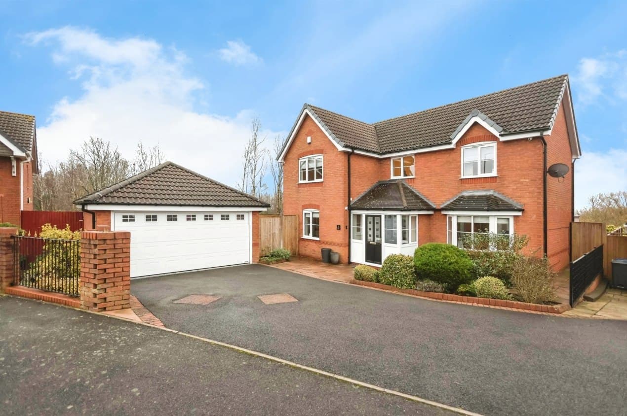Oldbury Road, Worcester: detached red-brick home with a double garage, bay frontage and tarmac drive under a blue sky, Platform Housing Group scheme