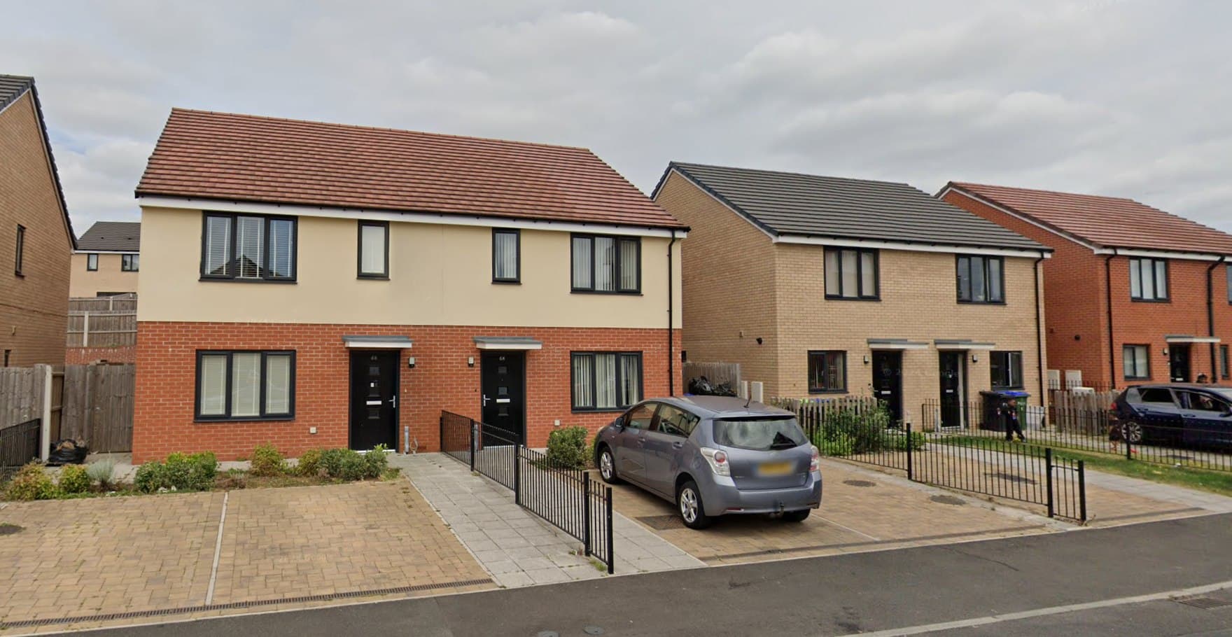West Road, Sandwell: a terrace of red-brick houses with white-framed bay windows and tiled roofs along a residential street, affordable housing for Sandwell MBC.