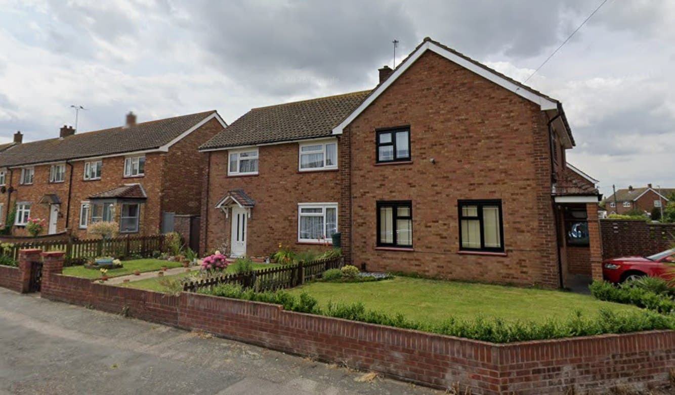 Claudian Way, Chadwell St Mary: pair of semi-detached homes in brick with rendered upper storeys and hipped roofs behind a low brick boundary wall, Thurrock Council scheme