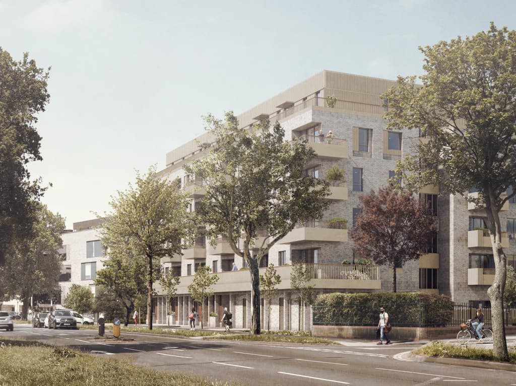 Honeypot Lane, Brent: render of a five-storey buff-brick apartment block on a tree-lined corner, with stepped upper floors, recessed balconies and street-level frontages, LB Brent affordable scheme