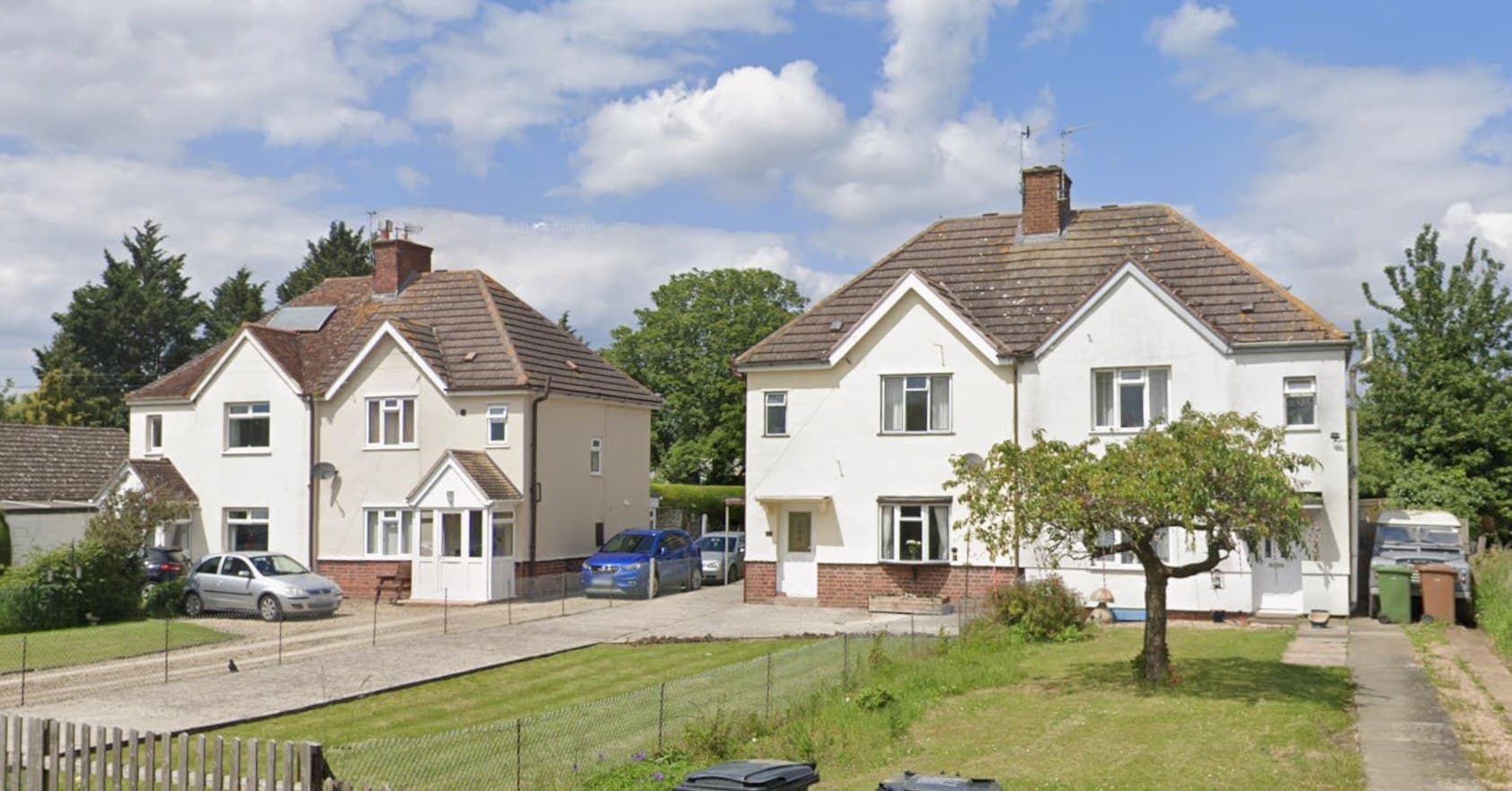 Shinehill Lane, South Littleton: white-rendered semi-detached houses with hipped roofs and front gardens along the lane, Platform Housing Group scheme
